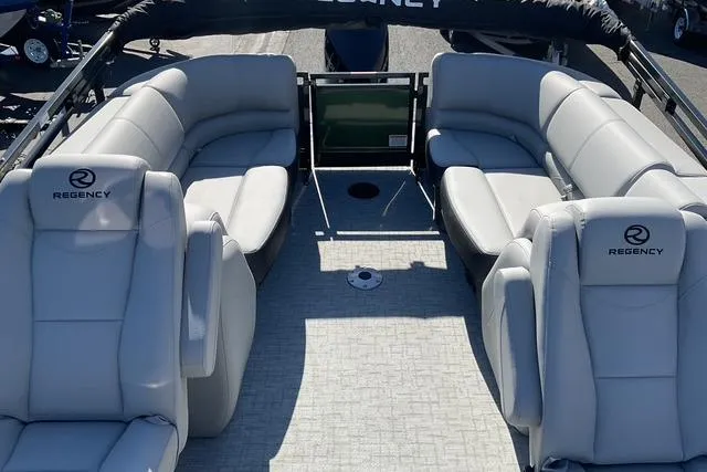 Slide: The Image of 2026 Regency 230 DL boat interior with plush seating and modern design. - 10