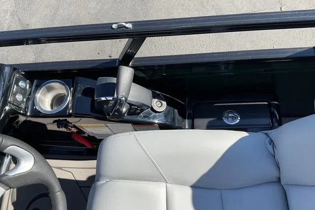 Slide: The Image of Interior view of 2026 Regency 230 DL boat, featuring steering wheel and control panel. - 6