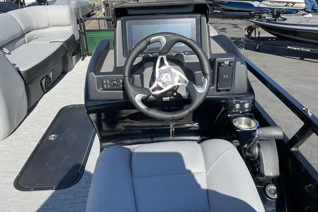Slide: The Image of Steering console of 2026 Regency 230 DL boat with modern controls and seating. - 7