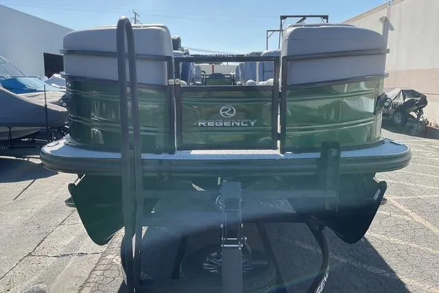 Slide: The Image of 2026 Regency 230 DL pontoon boat, rear view in a parking lot. - 8