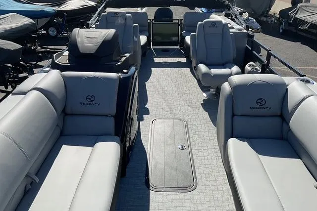 Slide: The Image of 2026 Regency 230 DL pontoon boat interior with plush seating and modern design. - 9