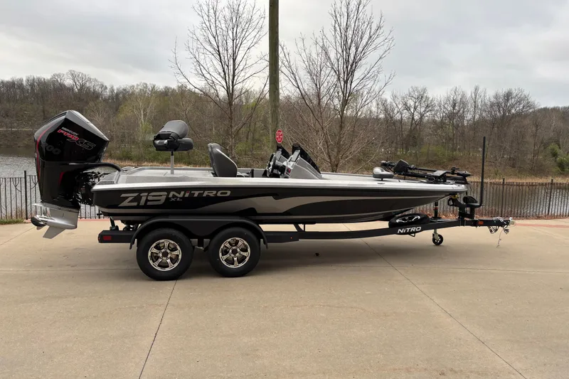 The Image of 2026 Nitro Z19 XL Pro boat on trailer, parked near a lake. - 0