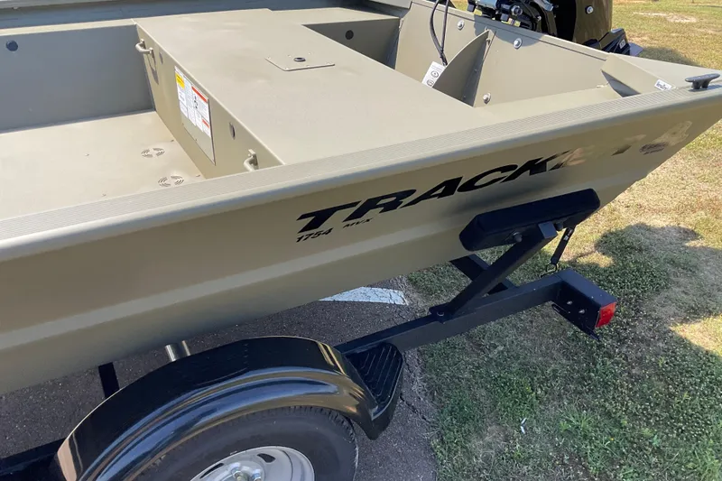 Slide: The Image of 2026 Tracker Grizzly 1648 Utility boat on trailer, parked on grass. - 2