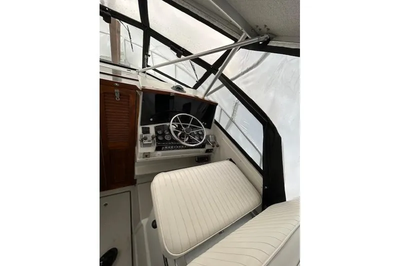 Slide: The Image of 1989 Rampage 28 Sportsman boat cockpit with steering wheel and seating. - 13