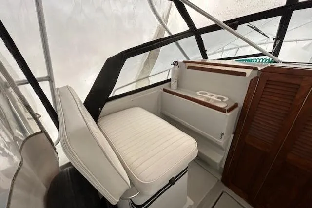 Slide: The Image of 1989 Rampage 28 Sportsman interior with white seating and wooden accents. - 14