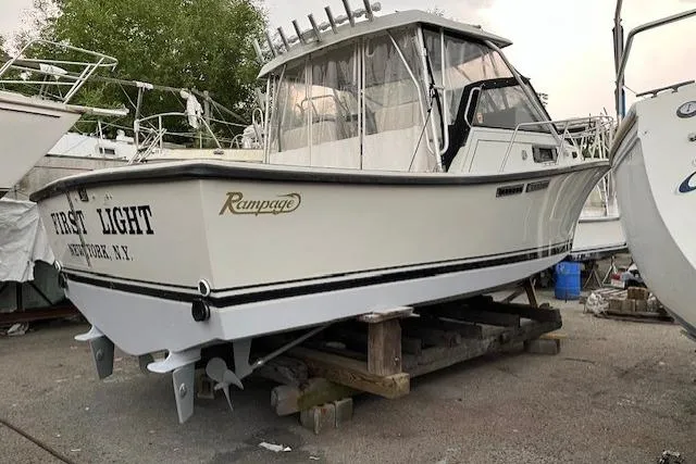 Slide: The Image of 1989 Rampage 28 Sportsman boat on dry dock, labeled "First Light," Newburgh, N.Y. - 3