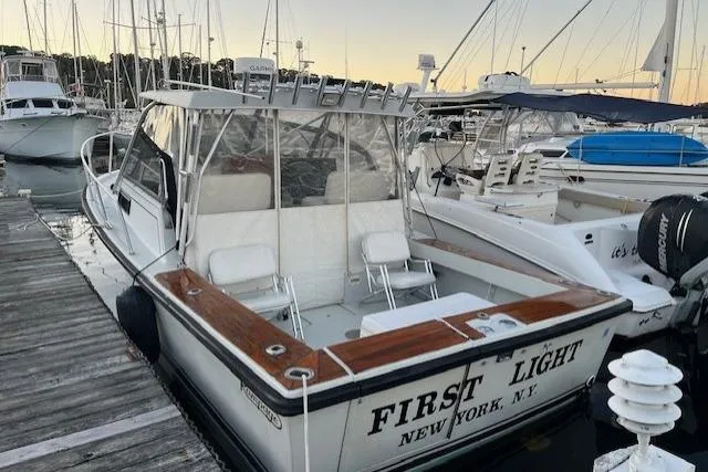 Slide: The Image of 1989 Rampage 28 Sportsman boat docked at marina, named "First Light," New York, NY. - 4