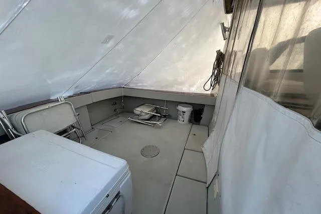 Slide: The Image of 1989 Rampage 28 Sportsman boat interior with covered deck and seating area. - 6