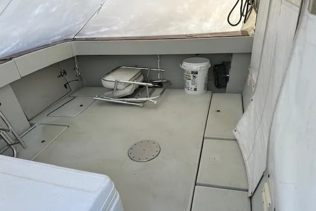 Slide: The Image of 1989 Rampage 28 Sportsman boat deck with fishing chair and equipment storage. - 7