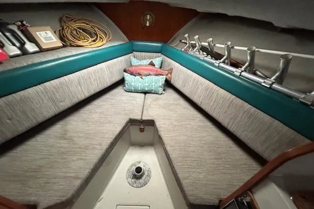Slide: The Image of 1989 Rampage 28 Sportsman cabin interior with seating, cushions, and fishing rod holders. - 9