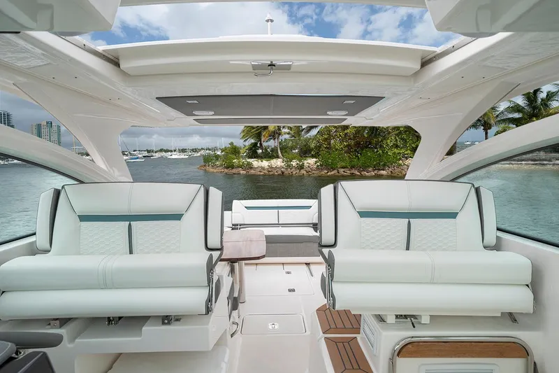 Slide: The Image of Manufacturer Provided Image: 2020 Tiara Sport 34 LX interior with luxurious seating and scenic water view. - 10