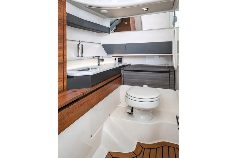 Slide: The Image of Manufacturer Provided Image: 2020 Tiara Sport 34 LX boat interior bathroom with modern fixtures and wooden accents. - 17