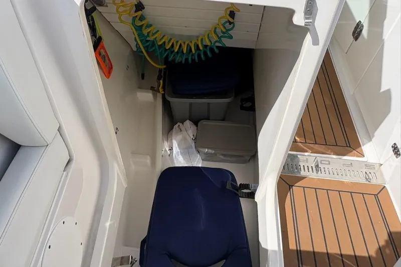 Slide: The Image of Interior view of 2020 Tiara Sport 34 LX boat cabin with seating and storage. - 21