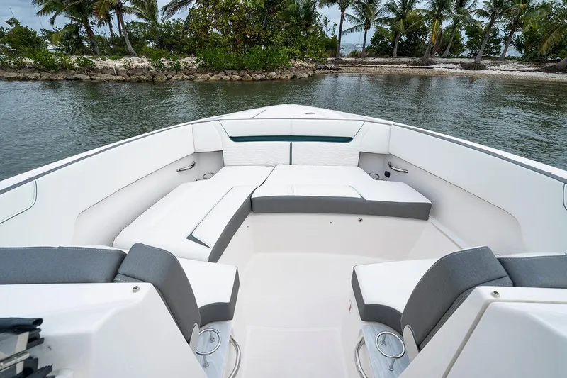 Slide: The Image of Manufacturer Provided Image: 2020 Tiara Sport 34 LX boat interior with seating, near tropical shoreline. - 4