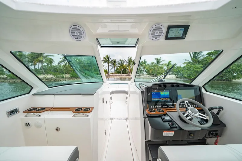 Slide: The Image of Manufacturer Provided Image: 2020 Tiara Sport 34 LX boat interior with modern helm and tropical backdrop. - 6