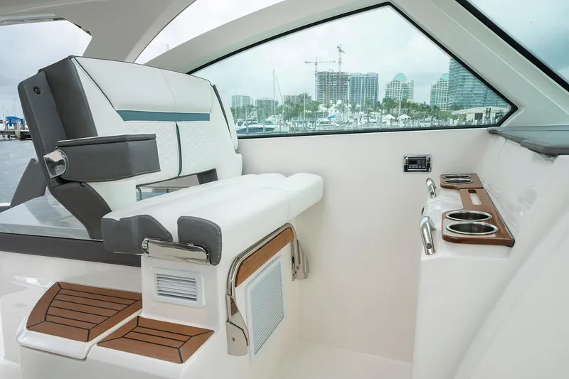 Slide: The Image of Manufacturer Provided Image: 2020 Tiara Sport 34 LX helm seat and console with cup holders. - 9