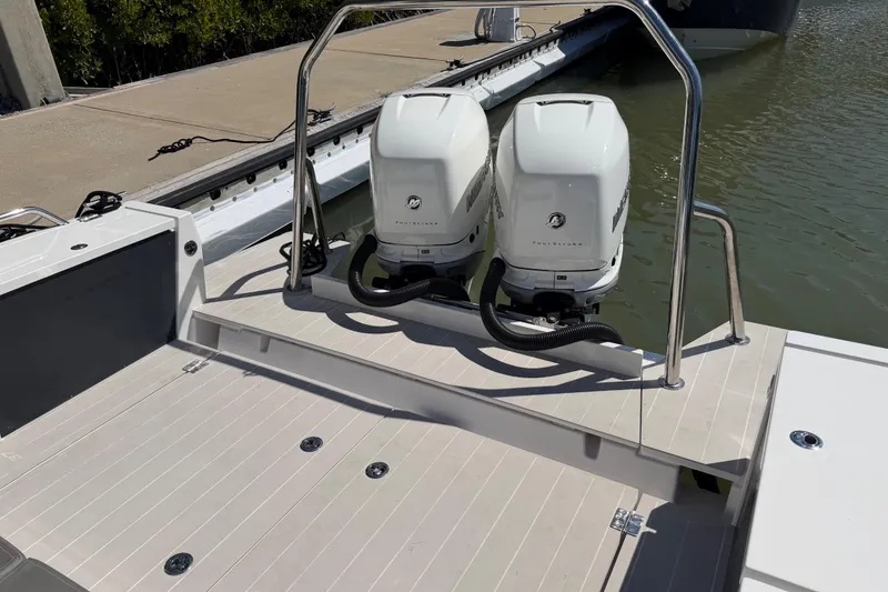 Slide: The Image of 2018 Axopar 37 Cabin boat with twin outboard engines at dockside. - 11