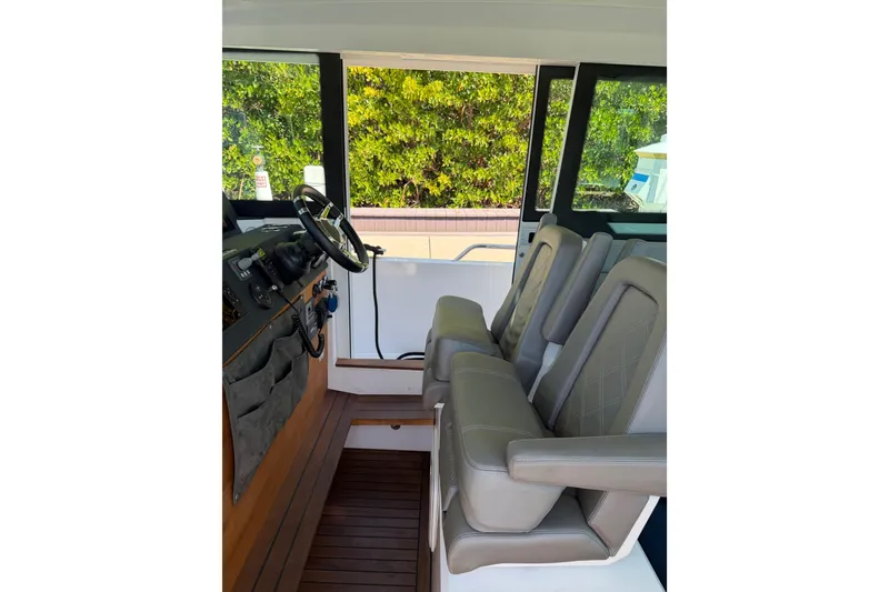 Slide: The Image of Interior of 2018 Axopar 37 Cabin with steering wheel and leather seats. - 15