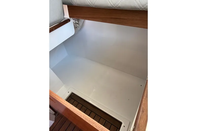 Slide: The Image of Interior storage compartment of 2018 Axopar 37 Cabin boat with wooden accents. - 19