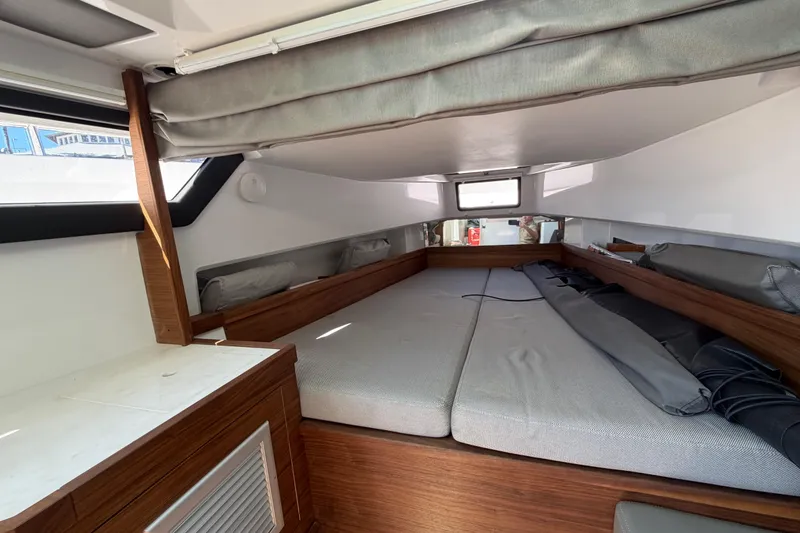 Slide: The Image of 2018 Axopar 37 Cabin interior with cozy sleeping area and modern wood accents. - 21