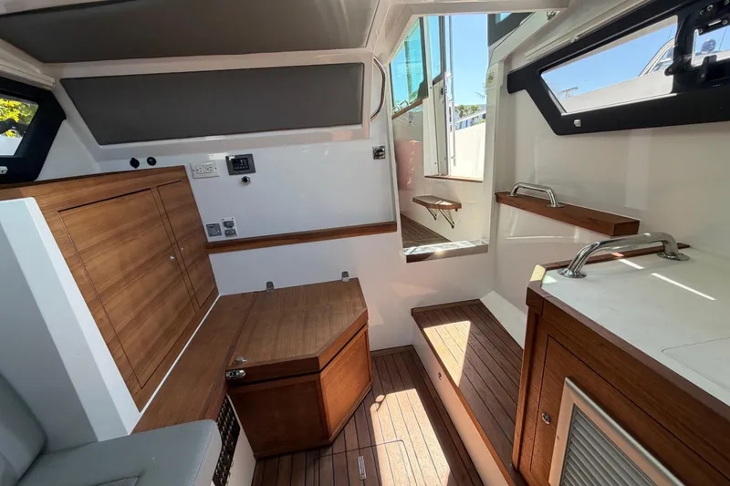 Slide: The Image of Interior of 2018 Axopar 37 Cabin with wooden cabinetry and modern design. - 22