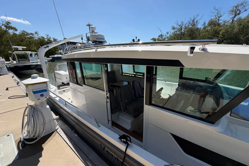 Slide: The Image of 2018 Axopar 37 Cabin boat docked, featuring sleek design and modern amenities. - 7