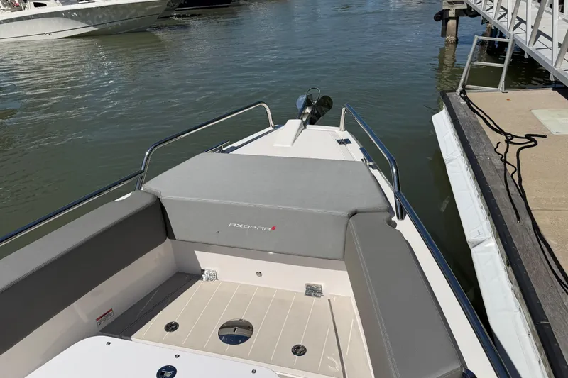 Slide: The Image of 2018 Axopar 37 Cabin boat docked, featuring sleek seating and modern design. - 8