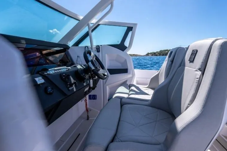 Slide: The Image of 2027 Axopar 29 Sun-Top boat interior with modern dashboard and comfortable seating. - 7