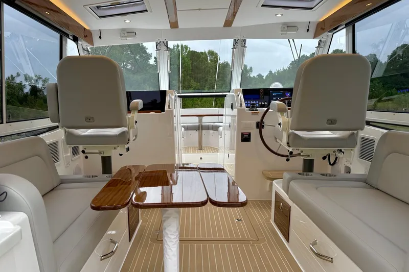 Slide: The Image of Luxurious interior of 2026 MJM 38x yacht with plush seating and modern helm. - 2