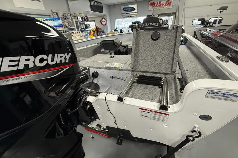 Slide: The Image of 2025 Lund 1675 Adventure SS boat with Mercury engine in showroom setting. - 10