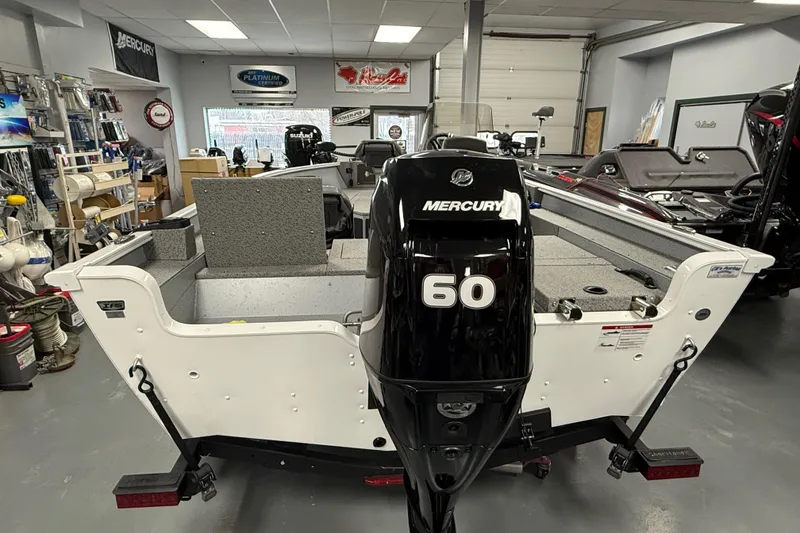 Slide: The Image of 2025 Lund 1675 Adventure SS boat with Mercury 60 outboard motor in showroom. - 12