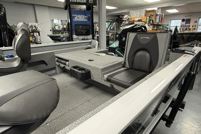 Slide: The Image of 2025 Lund 1675 Adventure SS boat interior with gray seating and storage compartments. - 13