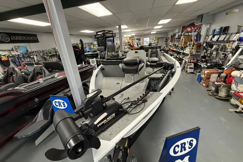 Slide: The Image of 2025 Lund 1675 Adventure SS boat displayed in a marine equipment store. - 8