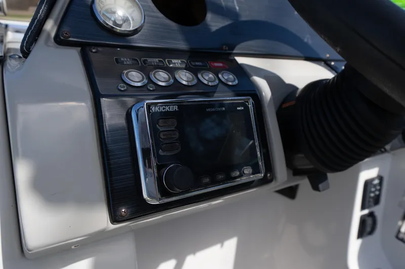 Slide: The Image of Control panel of 2017 Starcraft Crossover 231 SCX IO SURF boat with Kicker media center. - 11