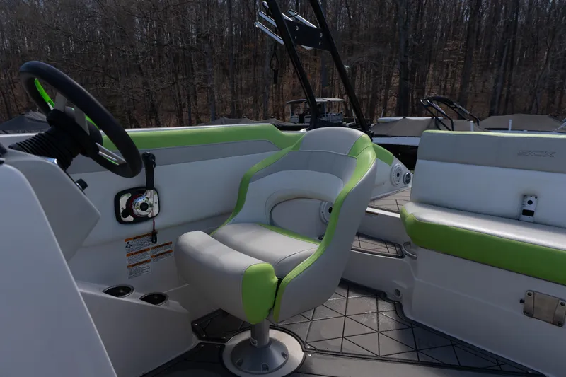 Slide: The Image of 2017 Starcraft Crossover 231 SCX IO SURF boat interior with green and white seating. - 13