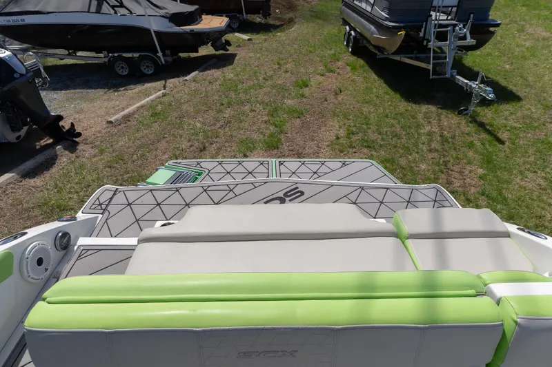 Slide: The Image of 2017 Starcraft Crossover 231 SCX IO SURF boat interior with green and gray seating. - 14