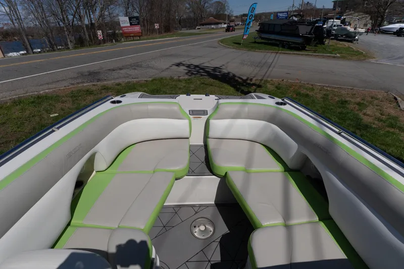 Slide: The Image of 2017 Starcraft Crossover 231 SCX IO SURF boat interior with green and beige seating. - 4