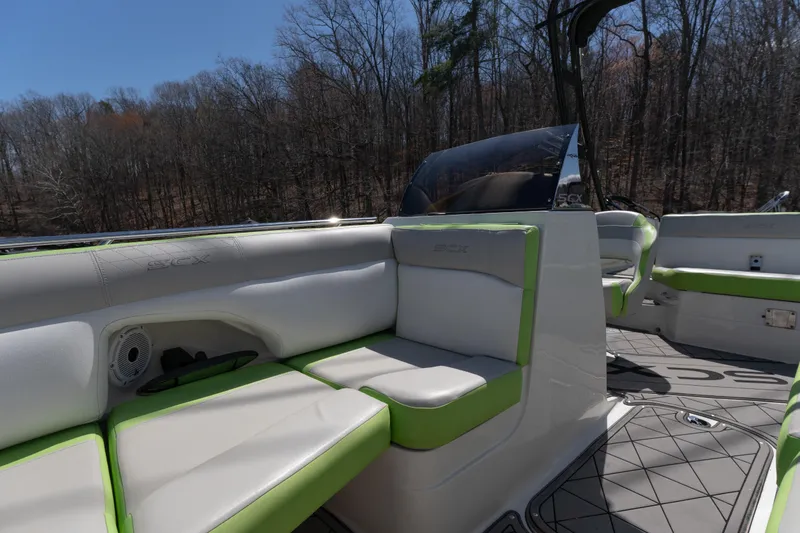 Slide: The Image of 2017 Starcraft Crossover 231 SCX IO SURF boat interior with green and white seating. - 5