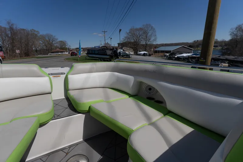 Slide: The Image of 2017 Starcraft Crossover 231 SCX IO SURF boat interior with green and white seating. - 6
