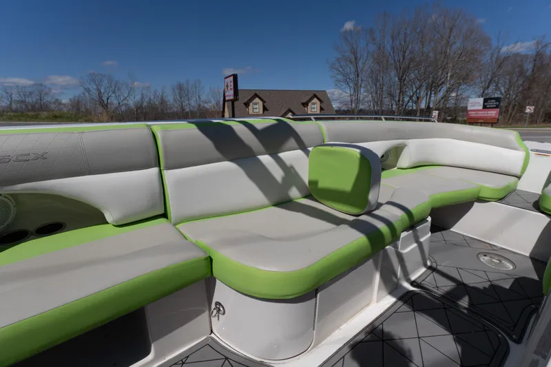 Slide: The Image of 2017 Starcraft Crossover 231 SCX IO SURF boat interior with green and white seating. - 9