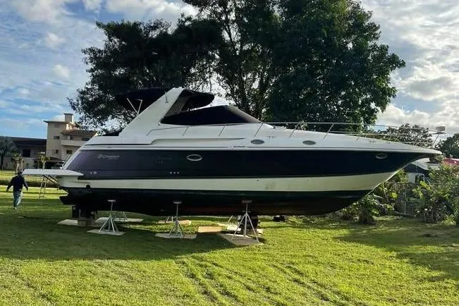 The Image of 2001 Cruisers Yachts 3870 Express displayed on grass. - 0