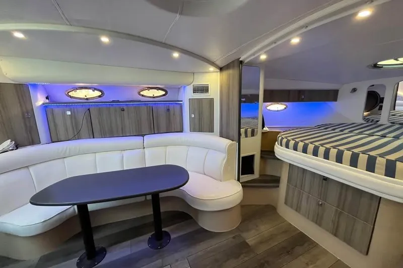 Slide: The Image of Luxurious interior of 2001 Cruisers Yachts 3870 Express with modern seating and ambient lighting. - 12