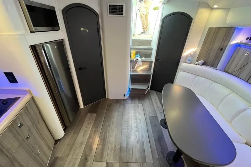 Slide: The Image of Interior of 2001 Cruisers Yachts 3870 Express with modern kitchen and seating area. - 14