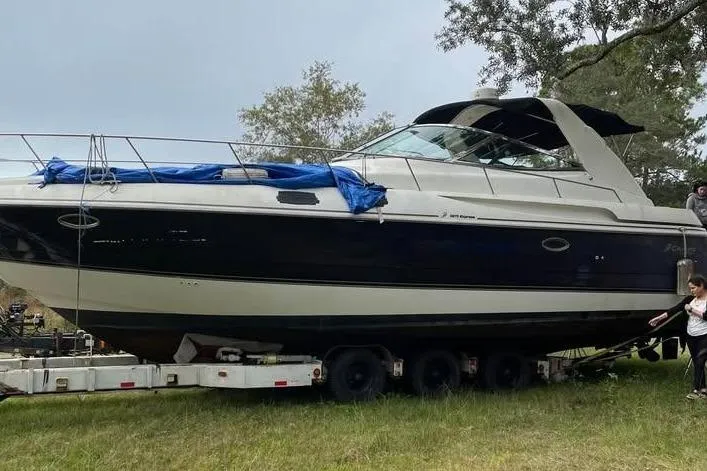 Slide: The Image of 2001 Cruisers Yachts 3870 Express on trailer outdoors. - 3