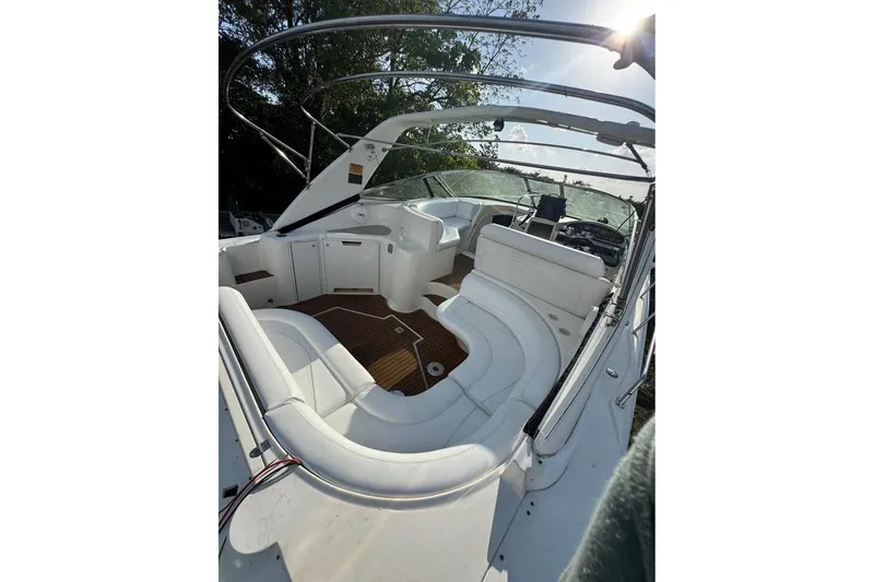 Slide: The Image of 2001 Cruisers Yachts 3870 Express interior with white seating and wooden flooring. - 5