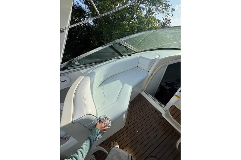 Slide: The Image of 2001 Cruisers Yachts 3870 Express interior with white seating and wooden flooring. - 9