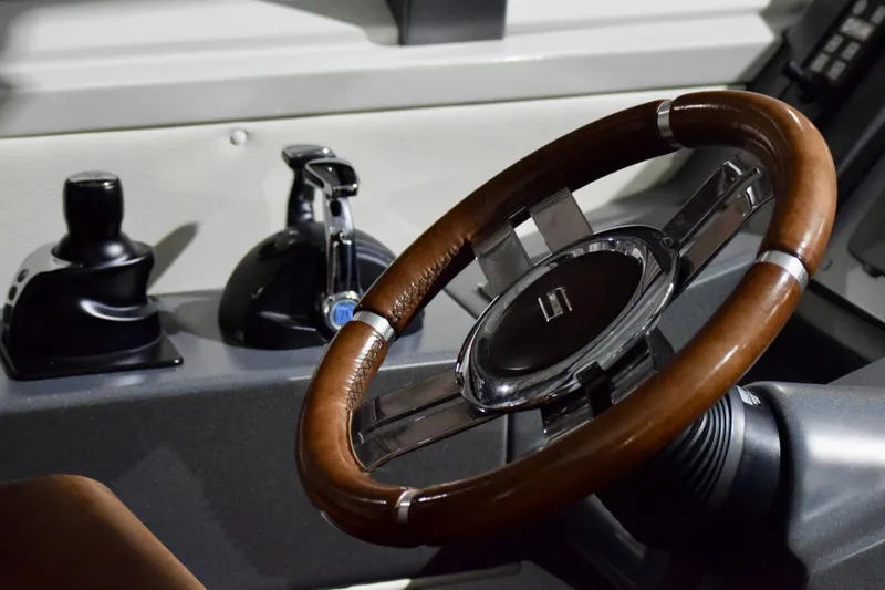 Slide: The Image of Steering wheel and controls of a 2010 Azimut 62S yacht. - 16