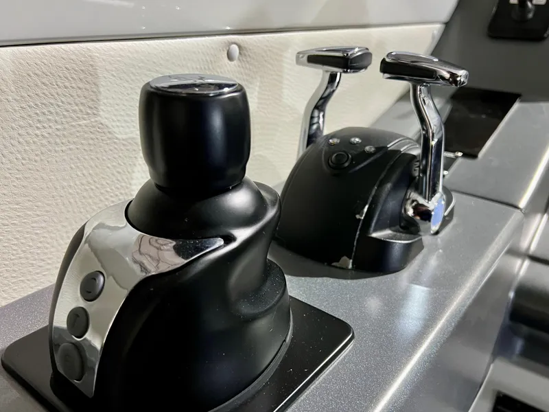 Slide: The Image of Control panel of a 2010 Azimut 62S yacht with joystick and throttle levers. - 17