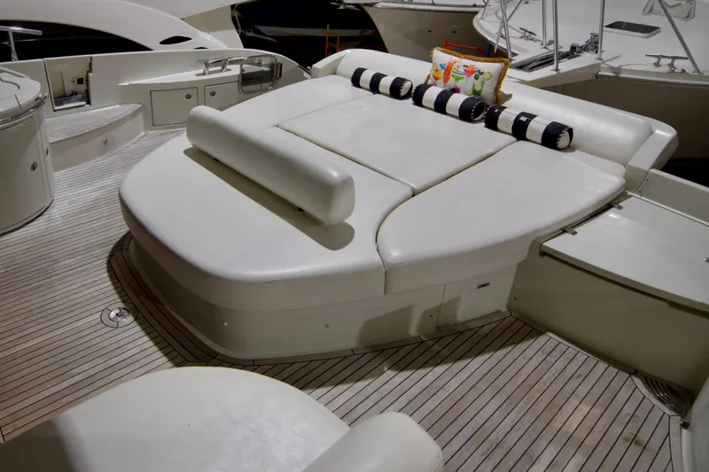Slide: The Image of 2010 Azimut 62S yacht with spacious sun deck and cushioned seating. - 8