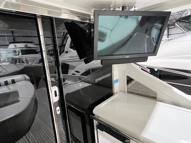 Slide: The Image of 2010 Azimut 62S yacht interior with TV and seating area. - 9